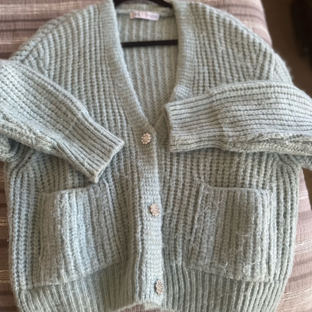Gorgeous cozy baby blue sweater with silver shimmering buttons.